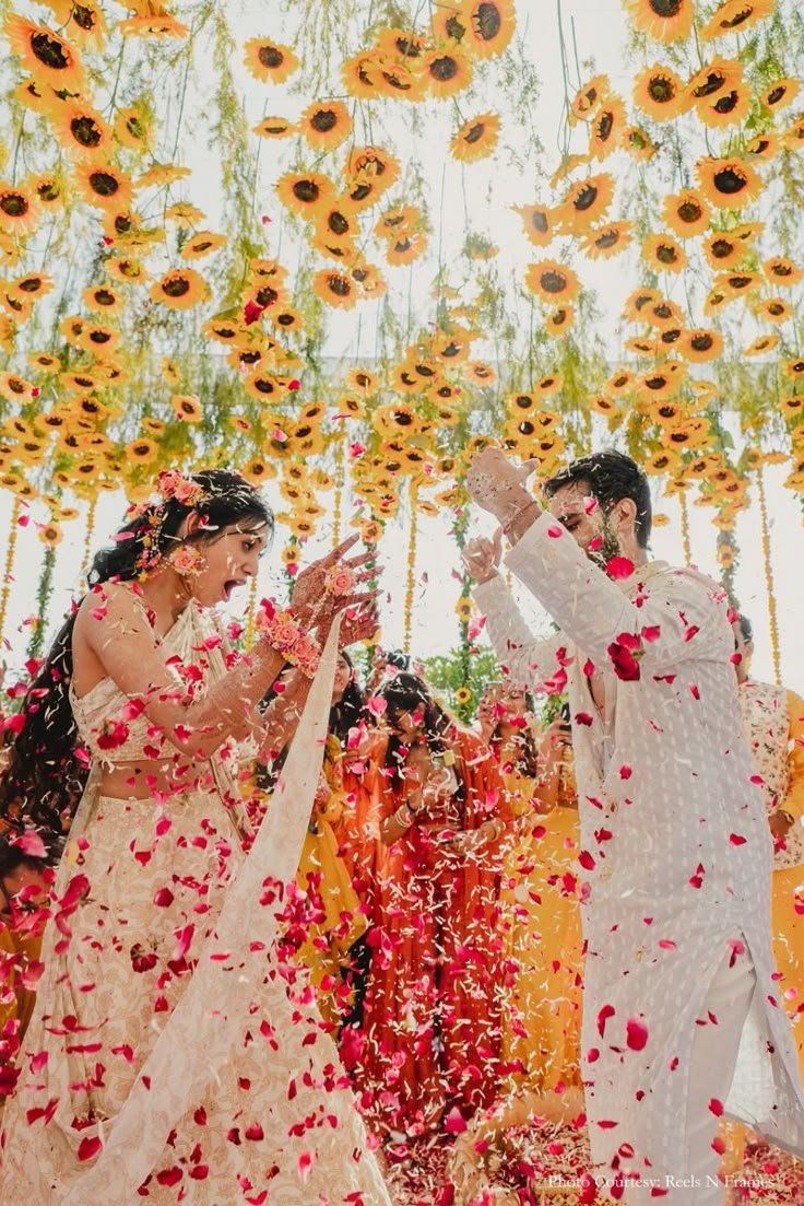 Elegant Haldi Celebration_ Couple in Ivory with Sunflower-Adorned Ceiling